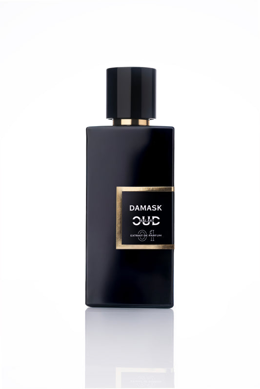 Black perfume bottle labeled 'Damask Oud malaki' on a white background